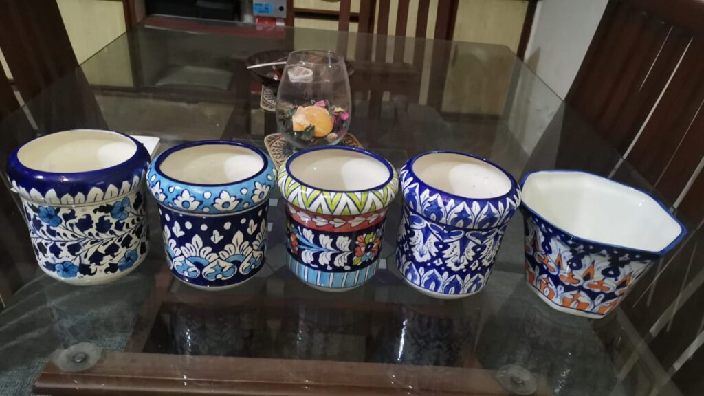 A collection of four decorative vases, each featuring unique and intricate designs.