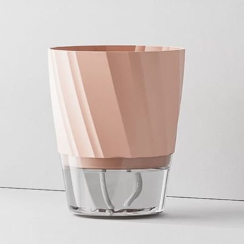 A pink cup featuring a transparent base, elegantly showcasing its vibrant color and unique design.